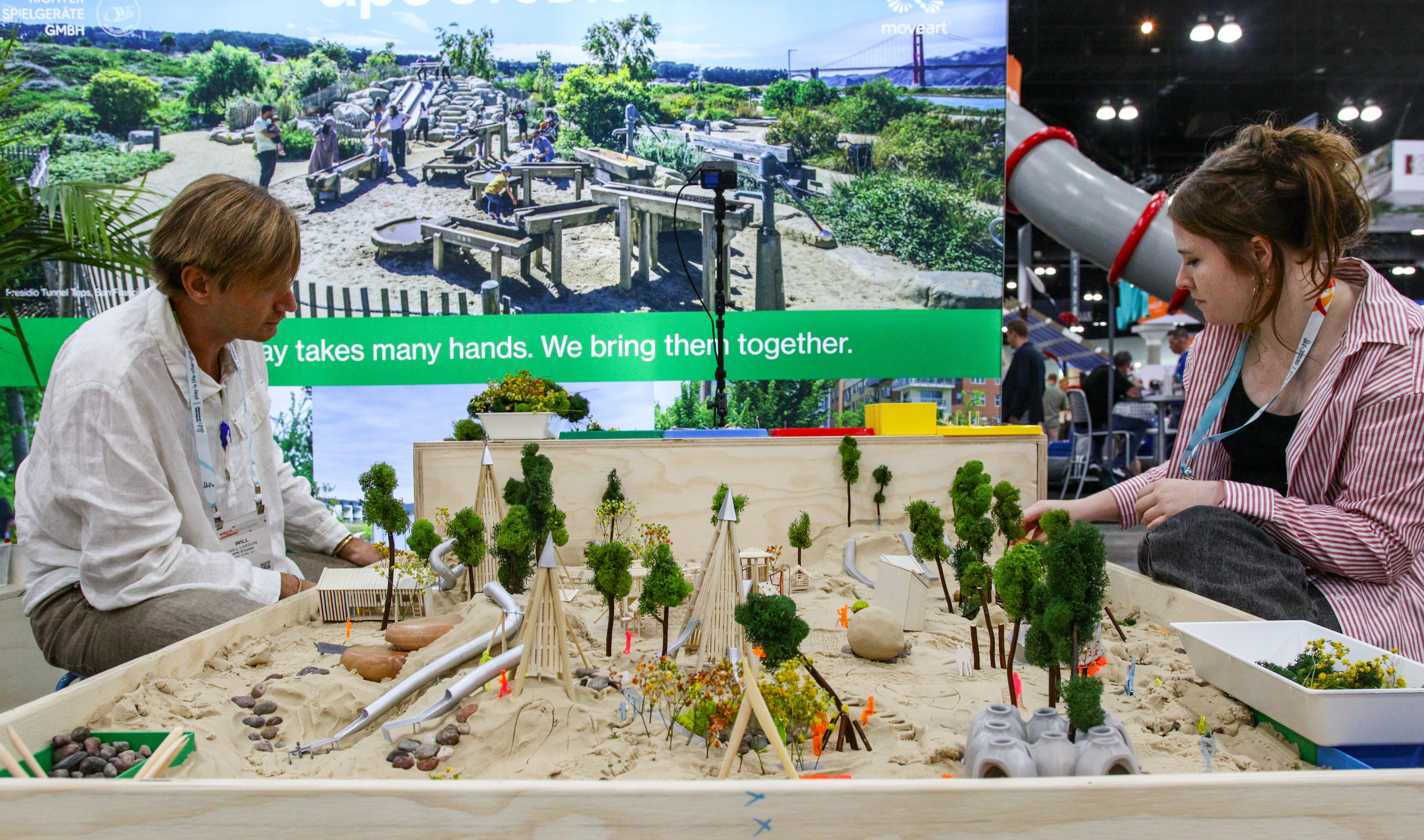 Attendees talking with an exhibitor at a booth on the ASLA 2026 EXPO floor