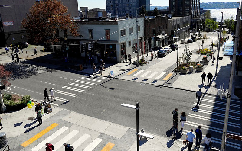 View overlooking two segments of the Bell Street Park bisected by a road.